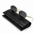 Christian Dior round sunglasses with gold metal frame and dark grey lenses, displayed on embossed black Christian Dior leather case