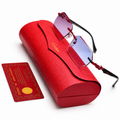 Cartier rimless sunglasses with blue-purple gradient lenses and red Cartier hardware, displayed on red Cartier leather case with authenticity card