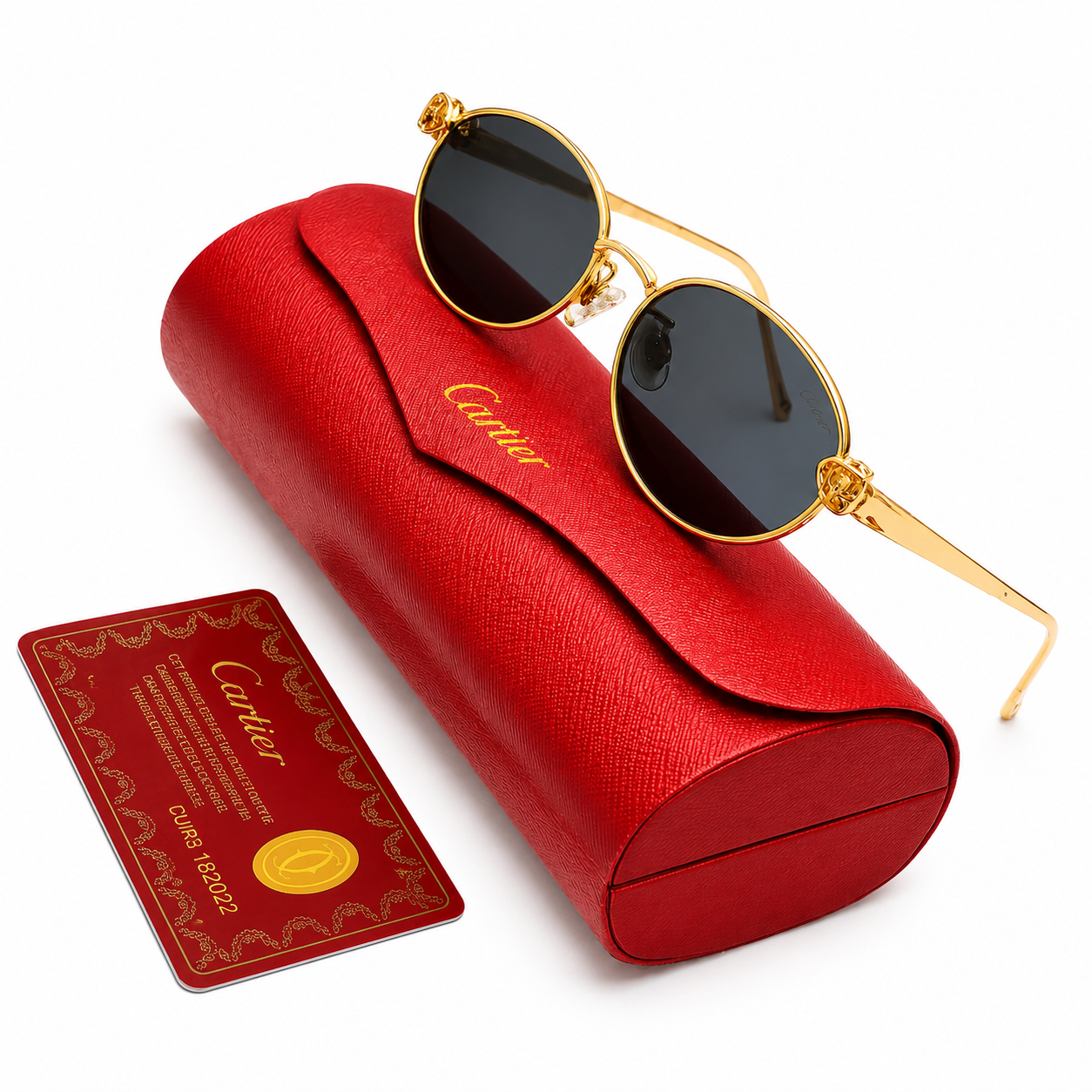 Cartier round sunglasses with 18k gold-tone frame, ornate fleur-de-lis hinge details and dark grey lenses, displayed on red Cartier leather case with authenticity card